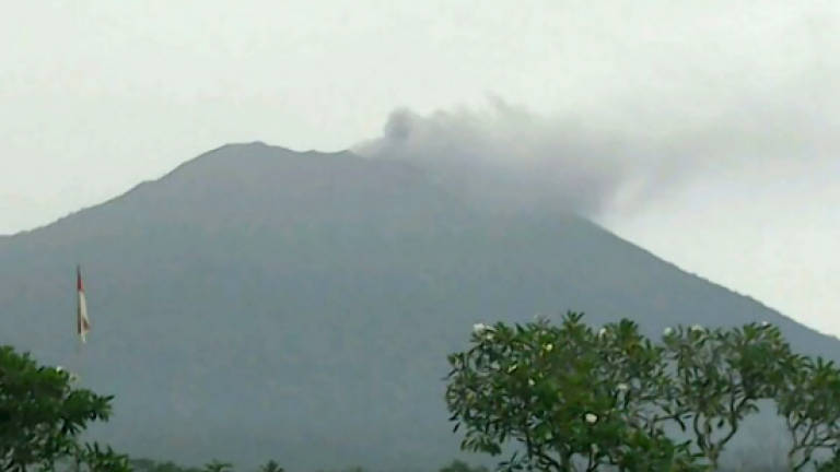 Bali volcano spews smoke and ash, raising eruption fears