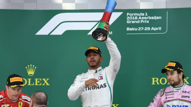 Hamilton wins chaotic Baku battle to lead title race