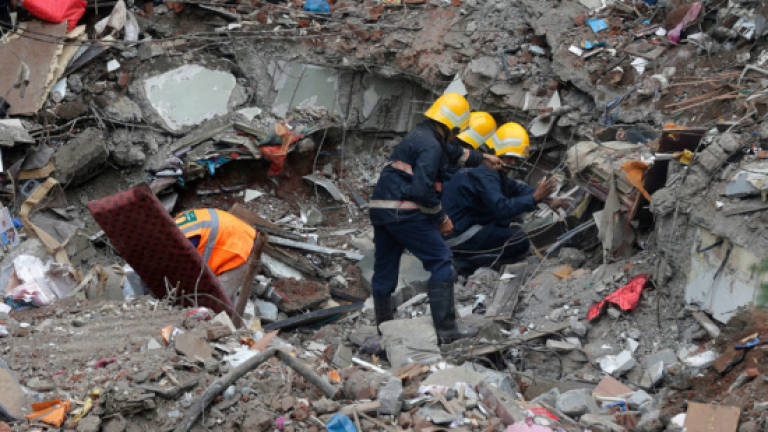 Indian police make arrest after building collapse kills 17