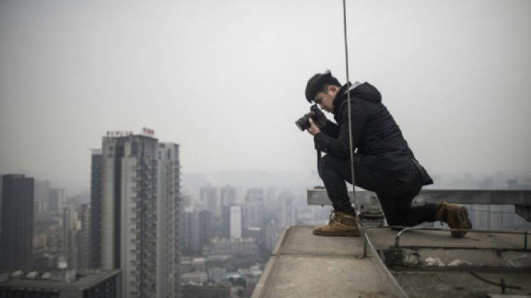 Chinese photographer undeterred by rooftopper's death