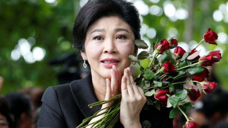 Roses, tears as Thai ex-PM Yingluck enters final stage of case