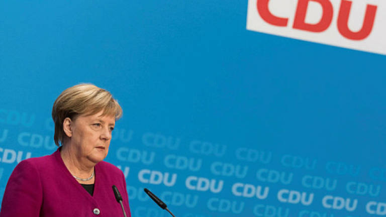 Merkel takes first step towards exit after poll drubbing