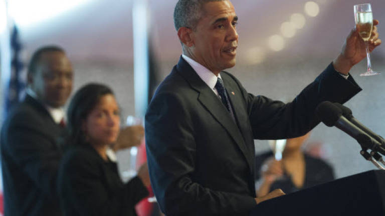 Obama vows to return to Kenya, without the suit