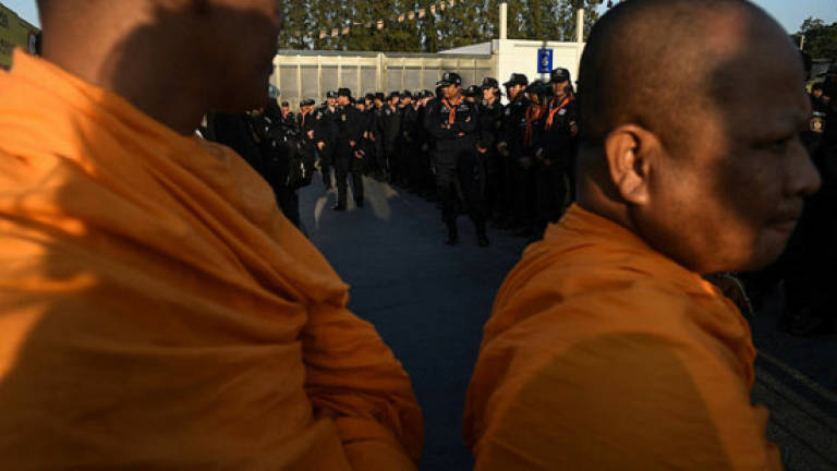 Thai cops search scandal-hit temple for wanted monk