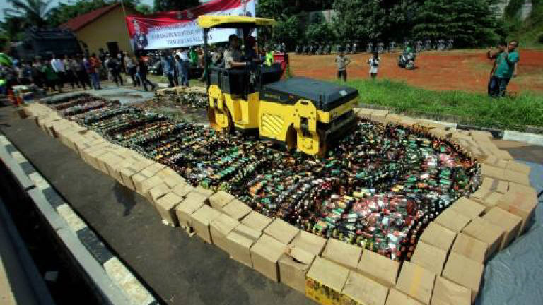 Indonesia steamrolls bootleg booze as death toll nears 100