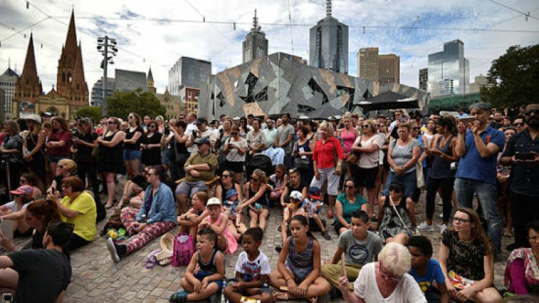 Melbourne vigil for shopping mall dead as suspect charged
