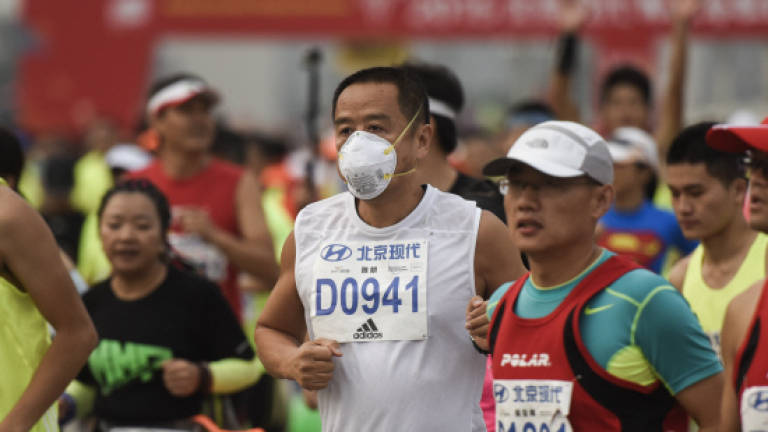 Beijing marathon sees seven heart attacks, unhealthy pollution levels