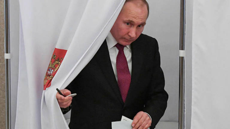 Putin eyes fourth term as Russians go to polls