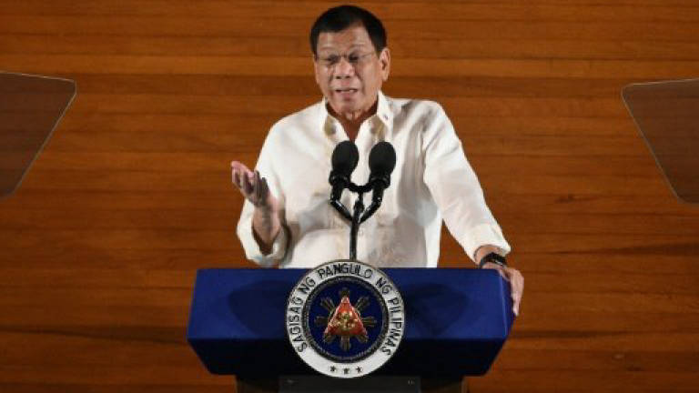 Philippine leader names, threatens officials over drugs