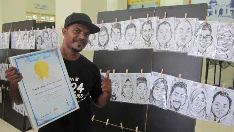 Caricature artist draws his way into Malaysian Book of Records