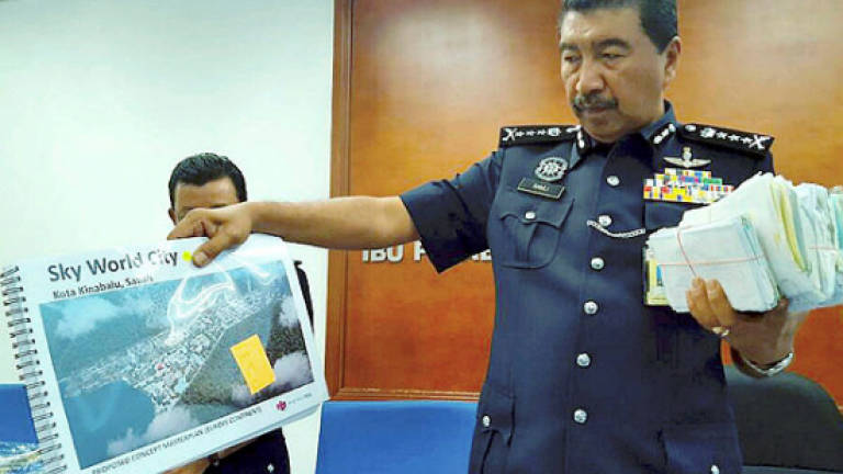 Police detain a man suspected of being involved in property scam syndicate