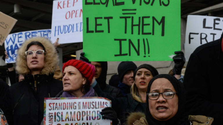 Judge blocks part of Trump's immigration ban for those in US