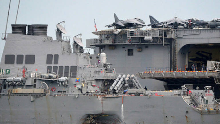 Search for missing crew of US destroyer enters third day