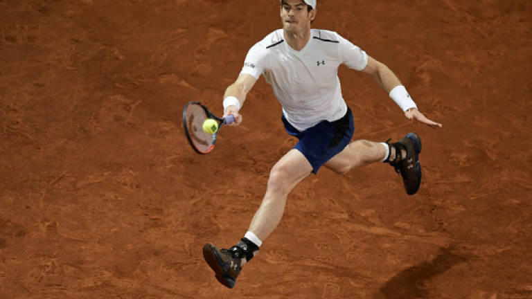 Murray bows out as Djokovic marches on in Madrid