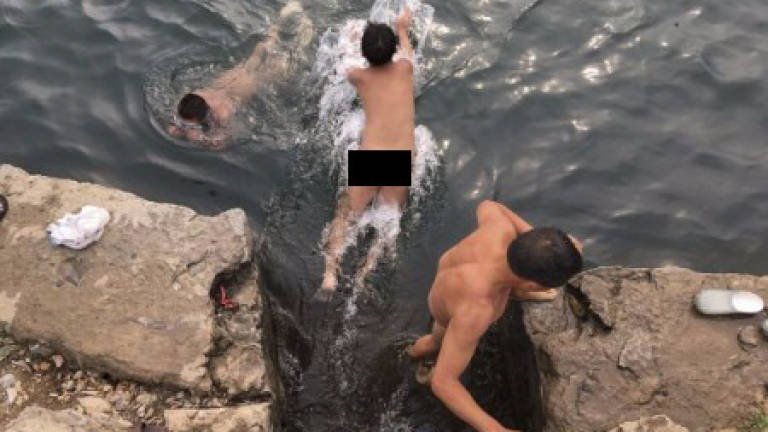 Chinese skinny-dippers defy public morals on nudity