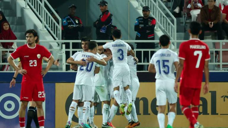 Uzbekistan's players celebrate following the own-goal scored by Indonesia during the U23 AFC Qatar 2024 Asian Cup semi-final match between Indonesia and Uzbekistan at Abdullah Bin Khalifa Stadium in Doha on April 29, 2024. - AFPPIX