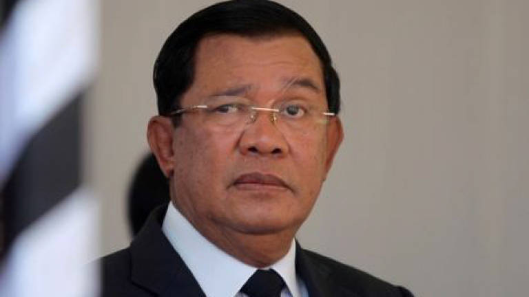 Cambodian PM pulls back on threat to shut rights group founded by rival