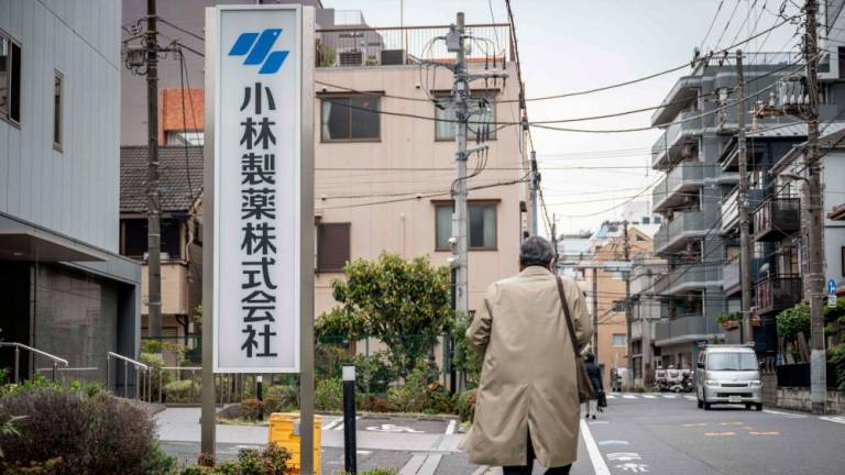 A man walks past a signage of Kobayashi Pharmaceutical outside of the company’s office in Tokyo on March 28, 2024/AFPPix