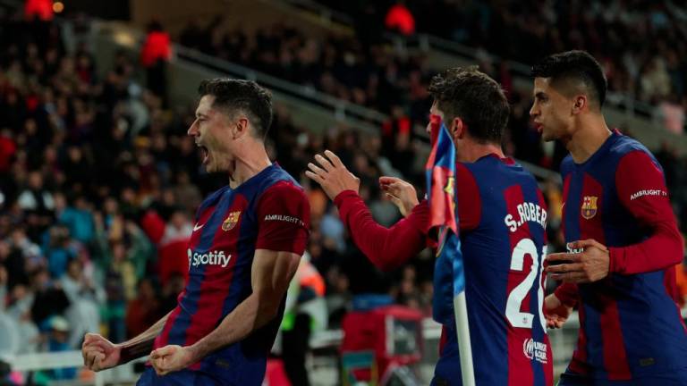 Barcelona's Polish forward #09 Robert Lewandowski celebrates with teammates after scoring his team's third goal during the Spanish league football match between FC Barcelona and Valencia CF at the Estadi Olimpic Lluis Companys in Barcelona on April 29, 2024. - AFPPIX