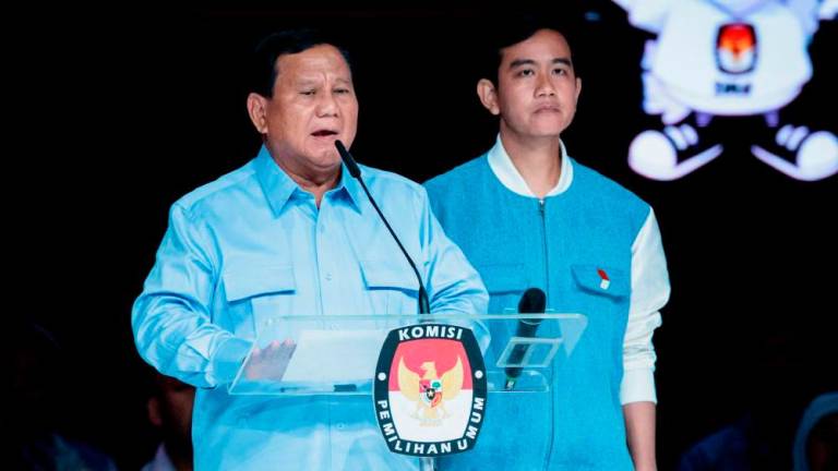 Filepix: Presidential candidate and Indonesia’s Defence Minister Prabowo Subianto (L) speaks beside vice presidential candidate Gibran Rakabuming Raka during the last presidential election debate at the Jakarta Convention Center (JCC) in Jakarta/AFPPix