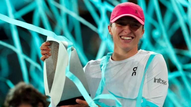 Poland's Iga Swiatek holds her trophy after beating Belarus' Aryna Sabalenka during the 2024 WTA Tour Madrid Open tournament final tennis match at Caja Magica in Madrid on May 4, 2024. - AFPPIX