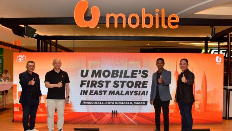 From left: U Mobile chief sales officer Alex Tan Kok Leong, CEO Wong Heang Tuck, Navin and chief technology officer Woon Ooi Yuen at the launch of its first store in Sabah.