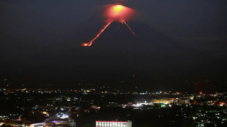 Philippine volcano 'fireworks' draw tourists as residents flee