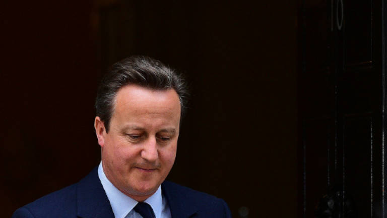 Cameron seeks to calm turbulent Britain after Brexit vote