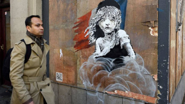 London builders cover up Banksy mural against France