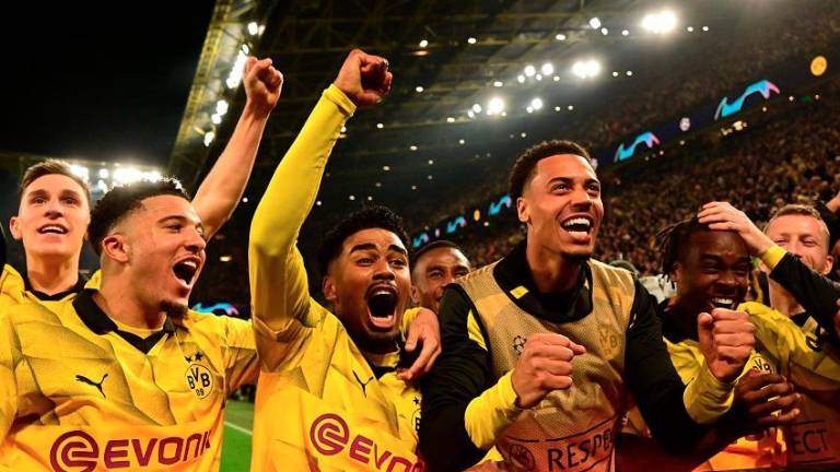 Dortmund’s players celebrate scoring their forth goal during the UEFA Champions League quarterfinal second leg match against Atletico Madrid. – AFPPIX