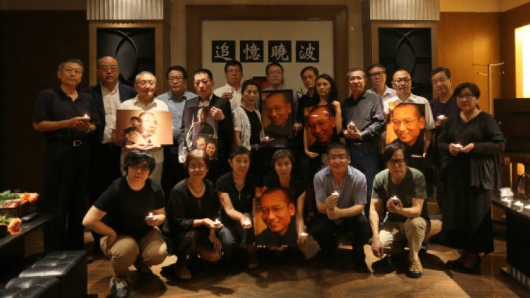 Late Chinese Nobel laureate's friends hold defiant memorial