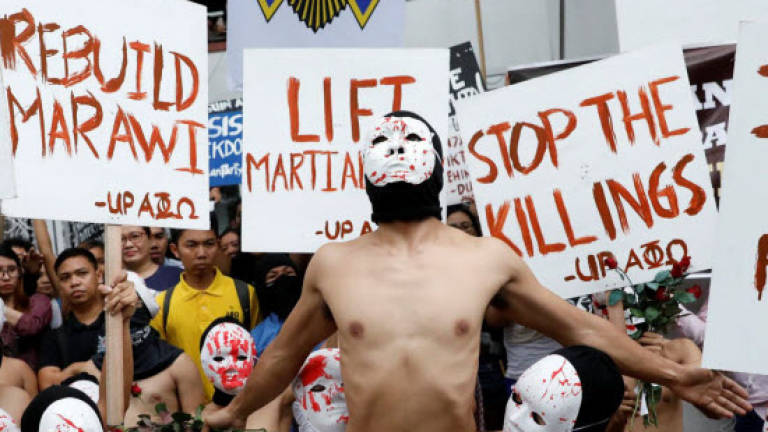 Skin in the game: Philippine students protest Duterte in naked run