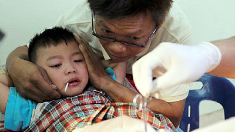 All eyes on three Chinese brothers at mass circumcision