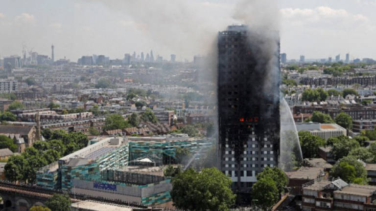 UK remembers deadly tower blaze, six months on