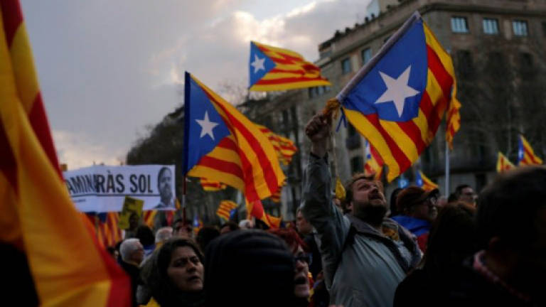 Catalan separatists face charges as key figure flees abroad