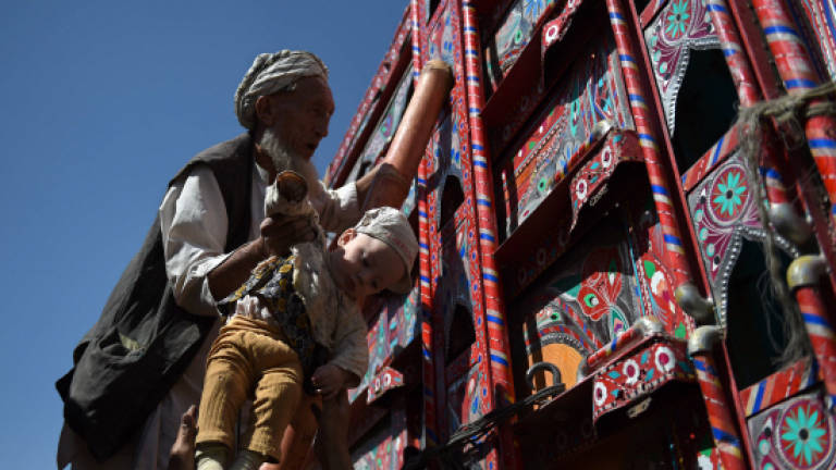 Afghan refugees return to uncertain future in alien homeland