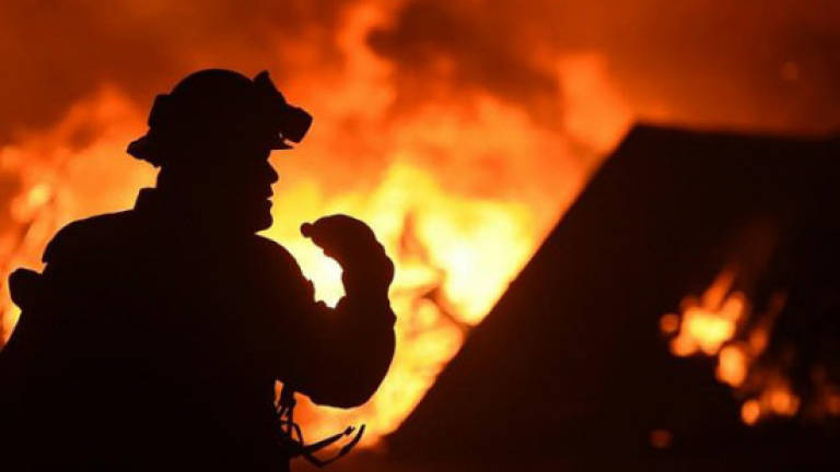 Wildfires rage in sweltering California forcing thousands to flee