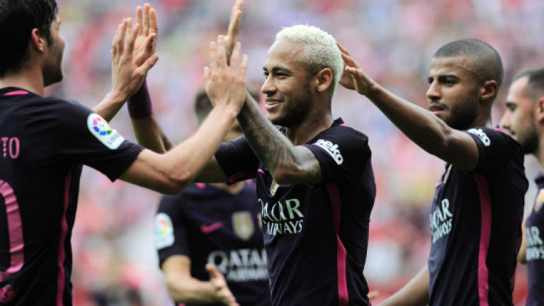 Suarez, Neymar fire Messi-less Barca top of La Liga