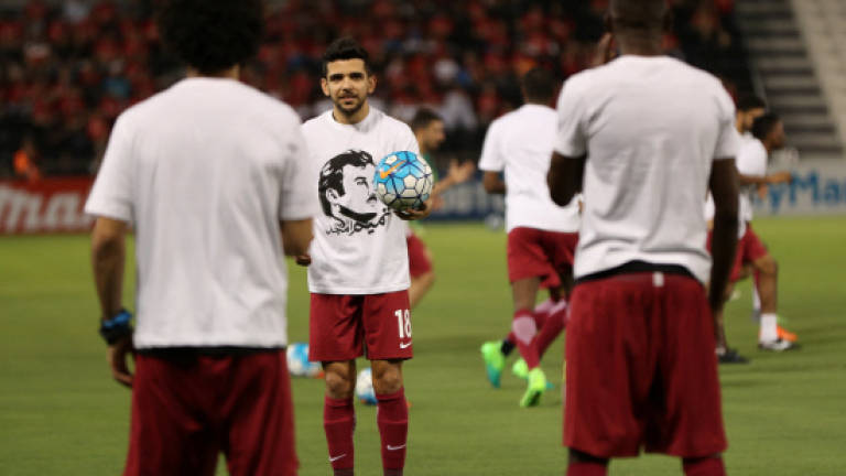 Qatar risks FIFA action in Emir T-shirt protest