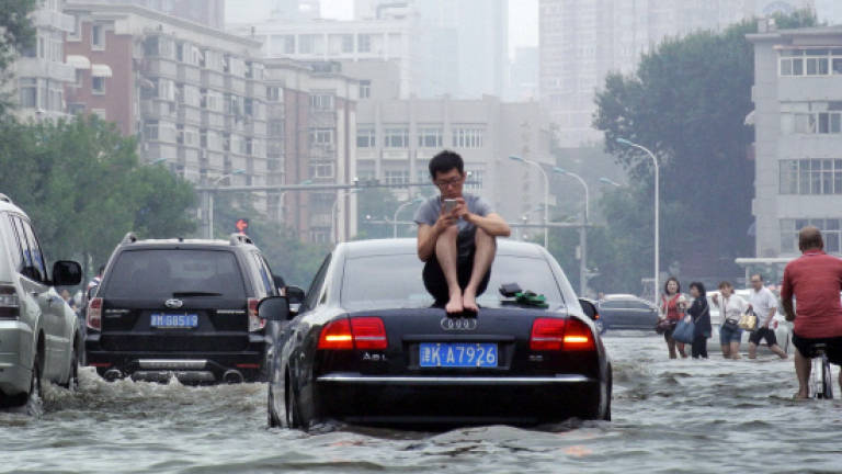 Nearly 100 dead or missing from China rains