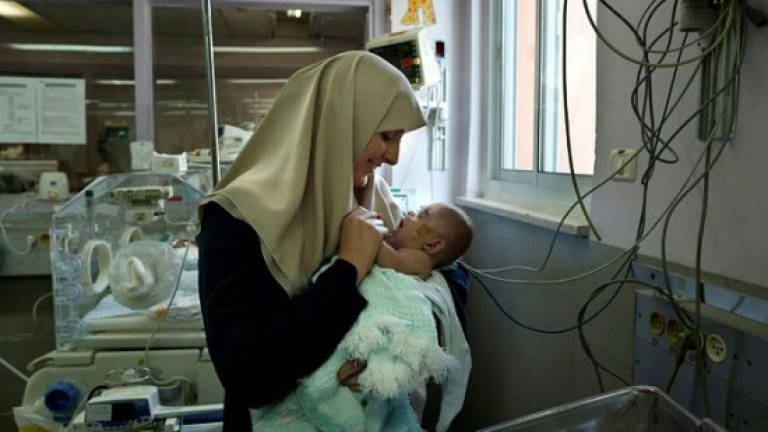 Gaza mother reunited with baby amid Israel entry row