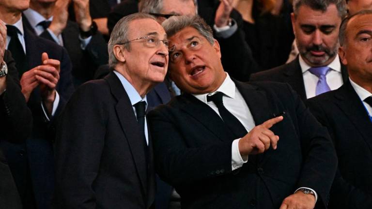 Real Madrid’s president Florentino Perez and Barcelona’s president Joan Laporta (C,R) talks during the Spanish league football match between Real Madrid CF and FC Barcelona at the Santiago Bernabeu stadium in Madrid on April 21, 2024/AFPPix