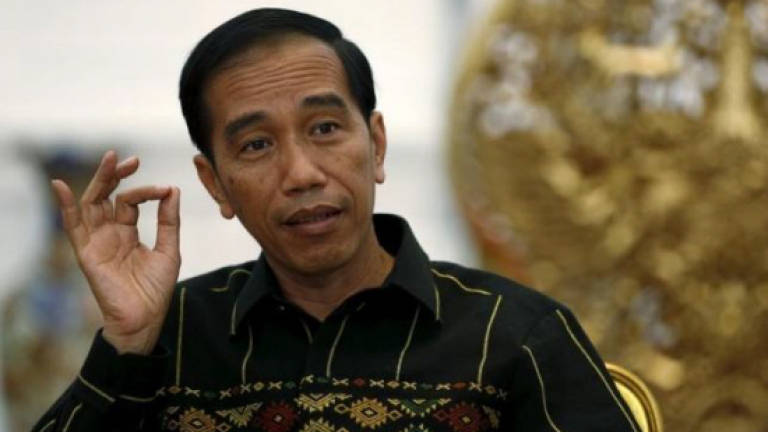 Indonesian leader visits South China Sea islands on warship