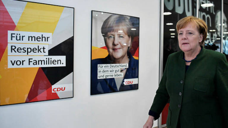 Merkel vows 'serious' coalition talks with SPD