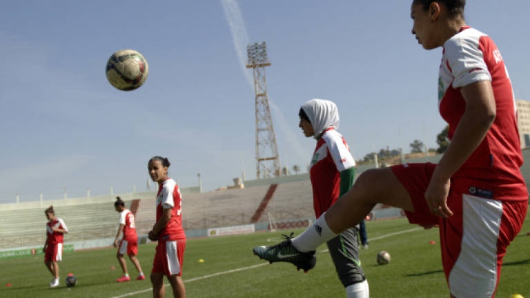 Algeria women footballers wave red card at stigma