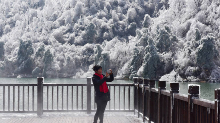 Asia shivers, slips and slides in record low temperatures