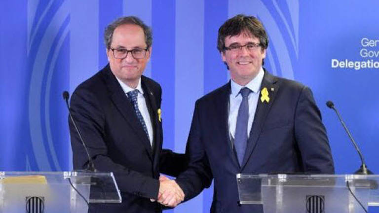 Catalan ex-leader, in Belgium, vows to press on with independence bid