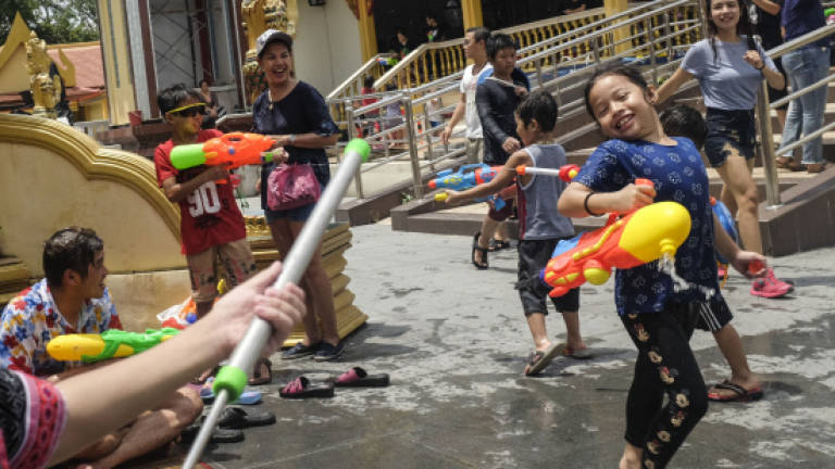 Revellers usher in Songkran with water pistols, buckets of water