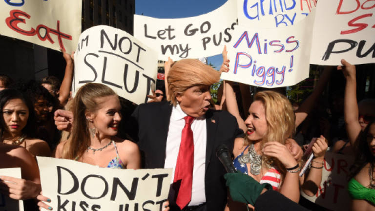 Bikini-clad models surround fake Trump in NYC stunt