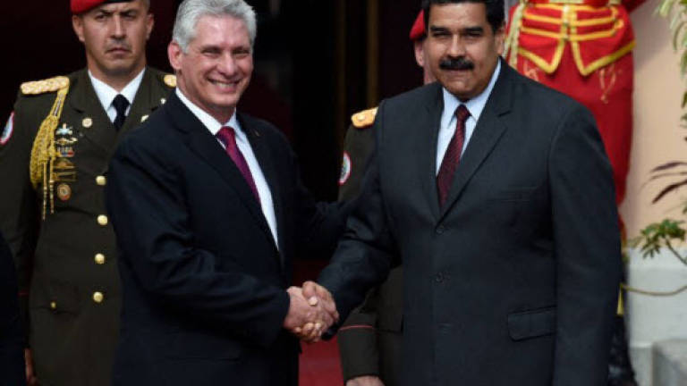 Cuban leader defends Maduro on first foreign visit